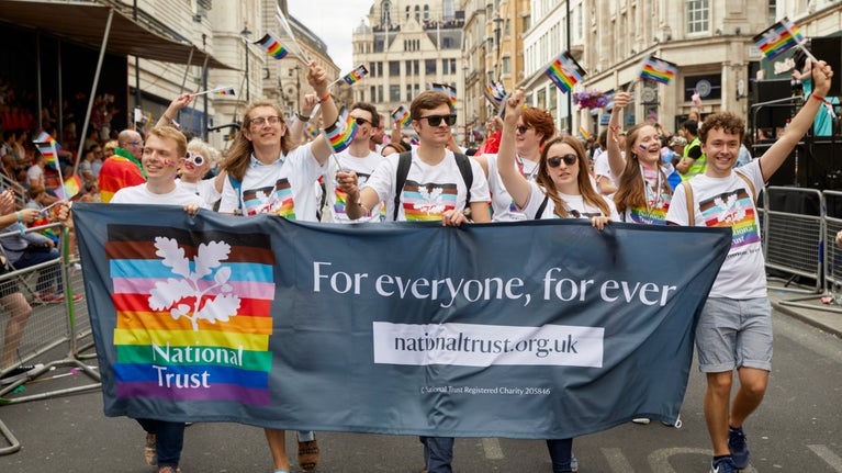 National Trust staff and volunteers walking in the parade at London Pride, July 2022